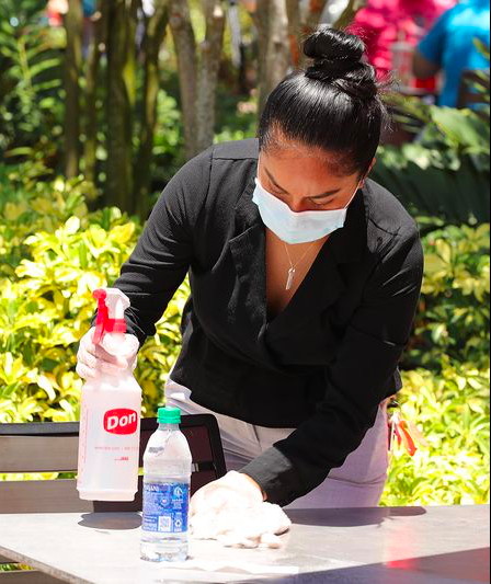 A restaurant crew sanitizing a table at Disney Springs [Source: Orlando Sentinel]