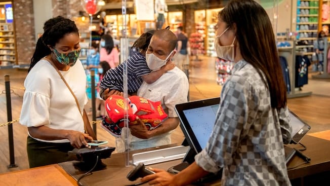 Family of Three Shopping at Disney Downtown District [Source: Disneyland]