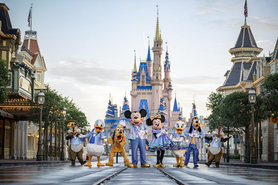 "Beginning Oct. 1, 2021, Mickey Mouse and Minnie Mouse will host “The World’s Most Magical Celebration” honoring the 50th anniversary of Walt Disney World Resort in Lake Buena Vista, Fla. Mickey and Minnie will be joined by their best pals Donald Duck, Daisy Duck, Goofy, Pluto and Chip ‘n’ Dale all dressed in sparkling new looks, custom-made for the 18-month event, highlighted by embroidered impressions of Cinderella Castle on multi-toned, EARidescent fabric punctuated with pops of gold." [Source: Disney (Matt Stroshane, photographer)]